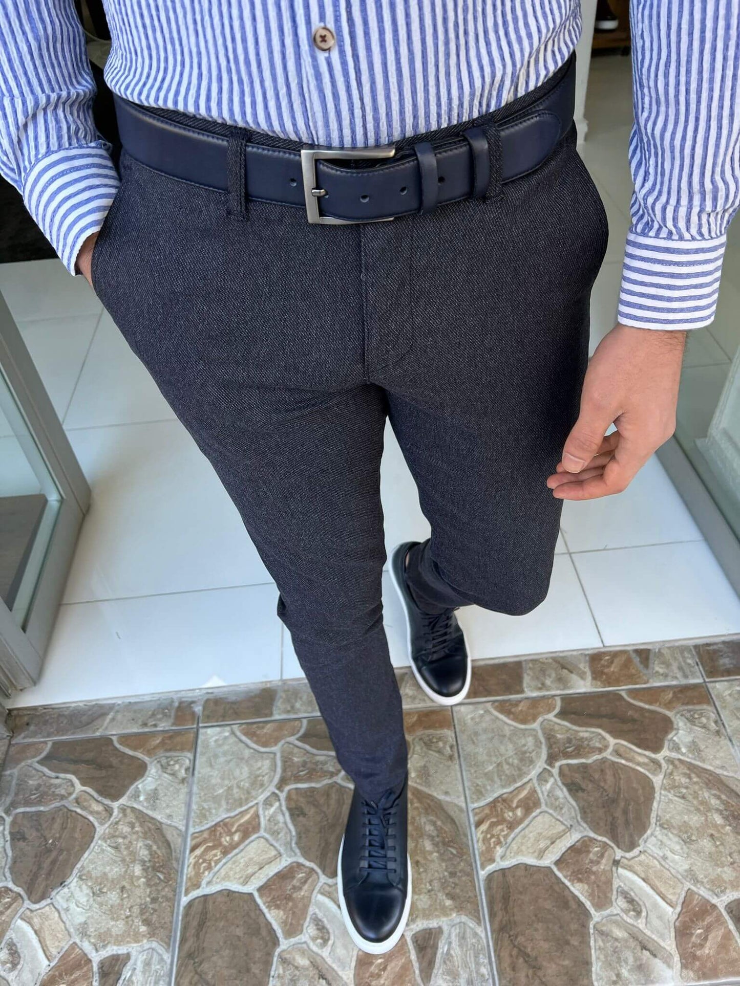 Navy blue pants tailored with a slim fit, delivering a sharp and tailored appearance
