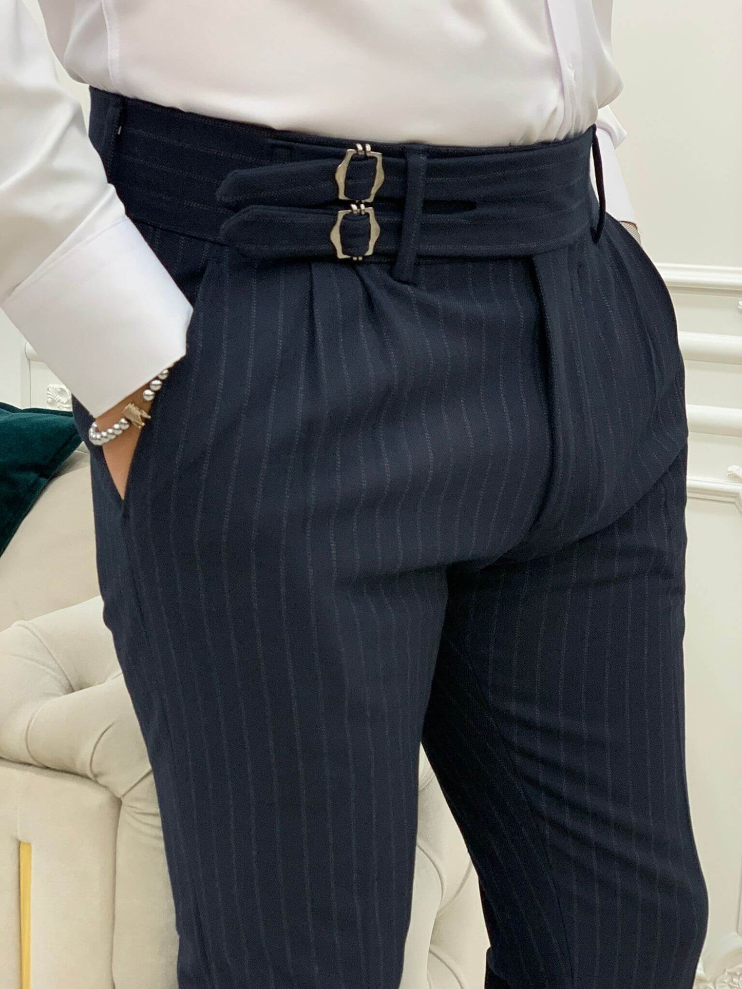 Navy blue striped pants with a stylish buckle detail