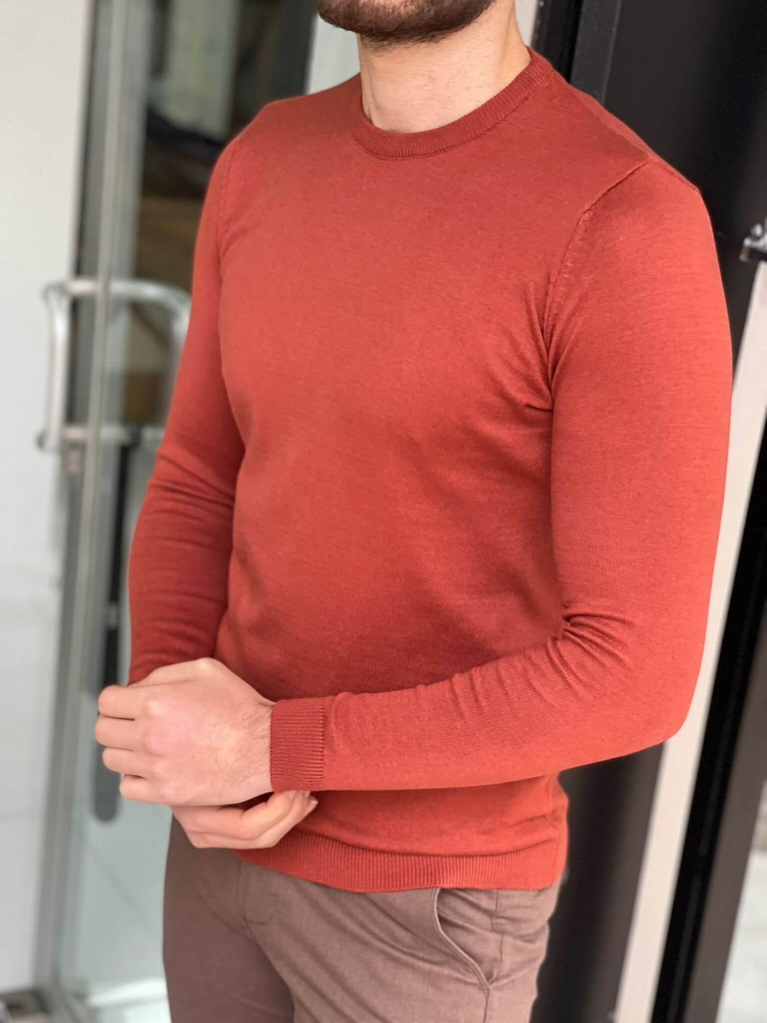 A cozy crewneck sweater in a textured tile pattern, featuring a blend of warm colors and a soft knit fabric."