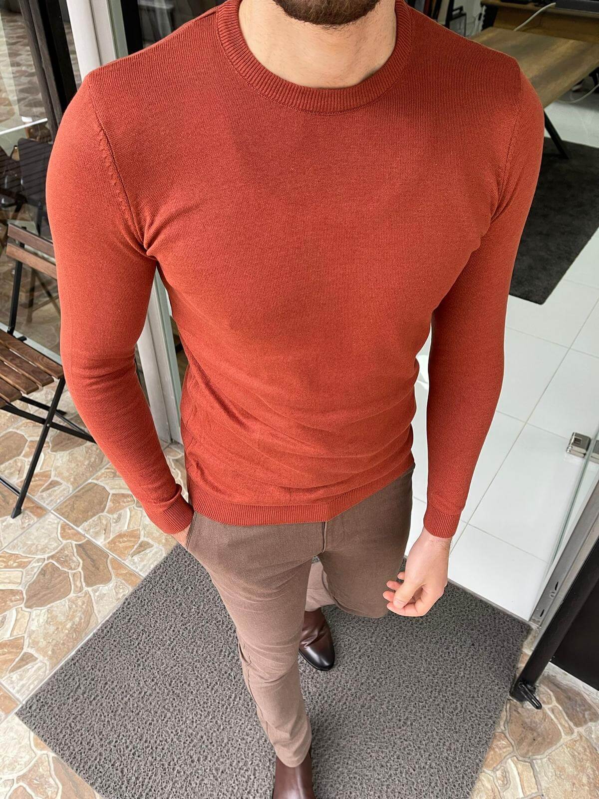 A cozy crewneck sweater in a textured tile pattern, featuring a blend of warm colors and a soft knit fabric."