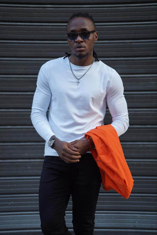  white combed crewneck sweater. The sweater features A crew neckline and a smooth, combed texture