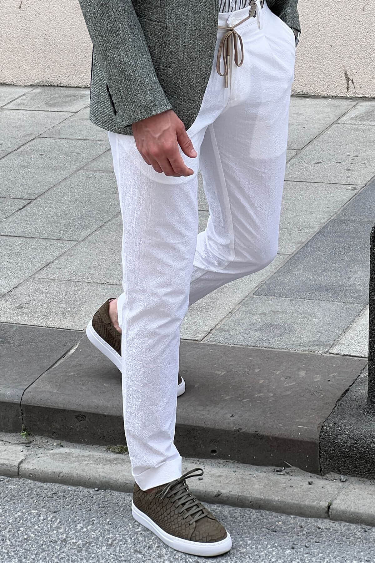 A Slim Fit White Cotton Trouser on display