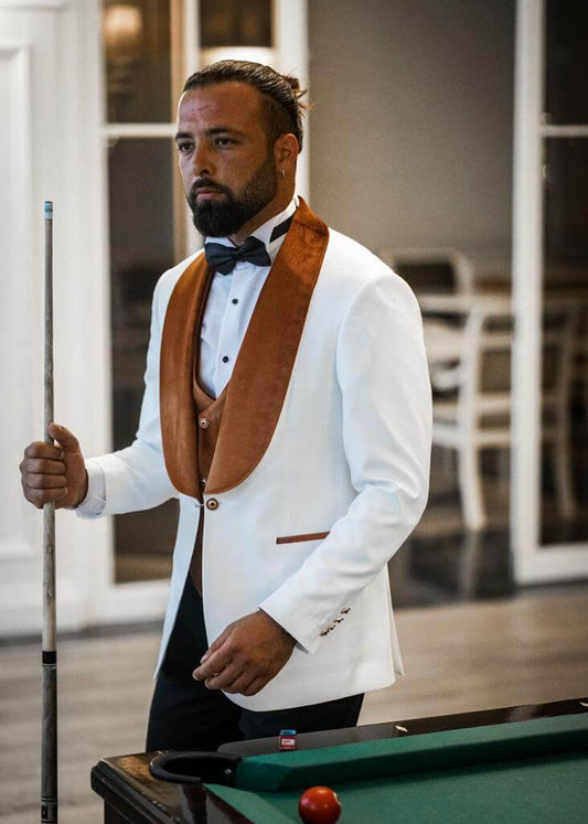 HolloMen slim-fit white tuxedo with bold orange velvet collar, featuring double slits, single-button closure, and full tuxedo set – jacket, vest, pants, shirt, and bow tie – from the Spring Summer Collection, ideal for modern weddings and evening celebrations.