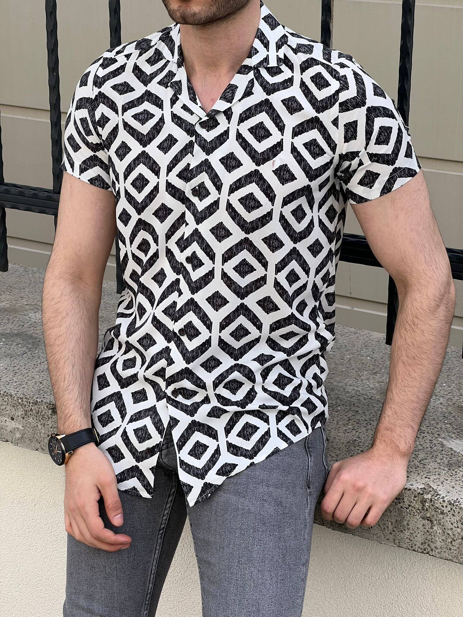 A  short sleeve shirt in white with an intricate pattern