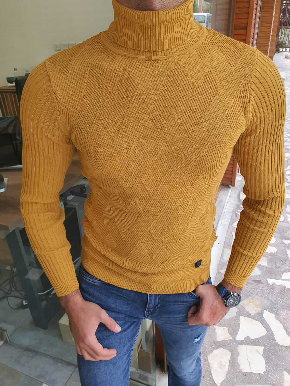 A  yellow long sleeve turtleneck sweater, featuring a high neckline and fitted sleeves."